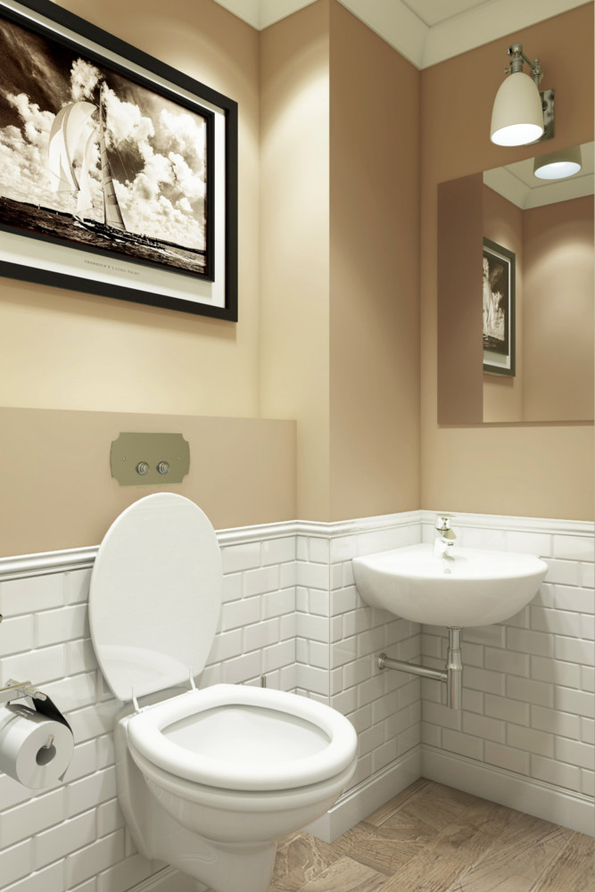 Туалет оформлен белой плиткой «метро» и краской карамельного оттенка.
