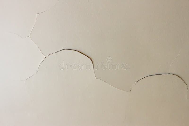 Crack on plasterboard white ceiling. Closeup on a crack in a white ceiling of a generic, unidentified old house stock photography
