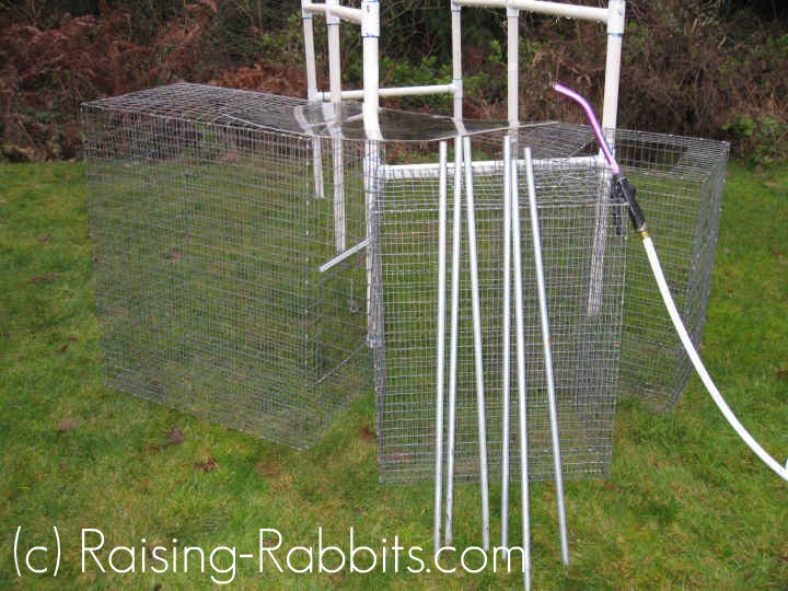 Cages and PVC rabbit hutch frame pulled outside and dismantled for cleaning.